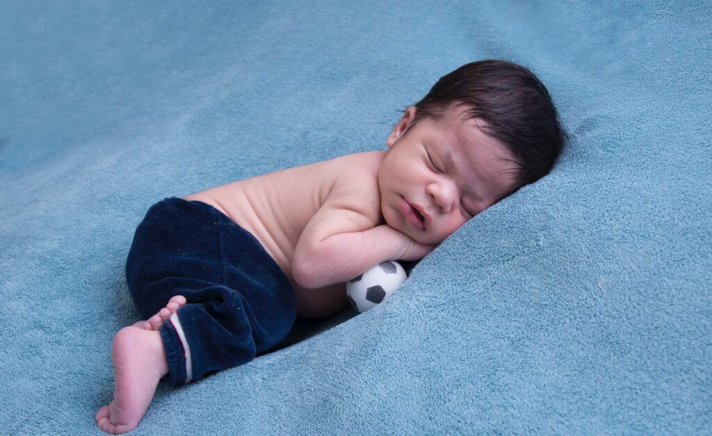 Baby sleeping on stomach with head turned right